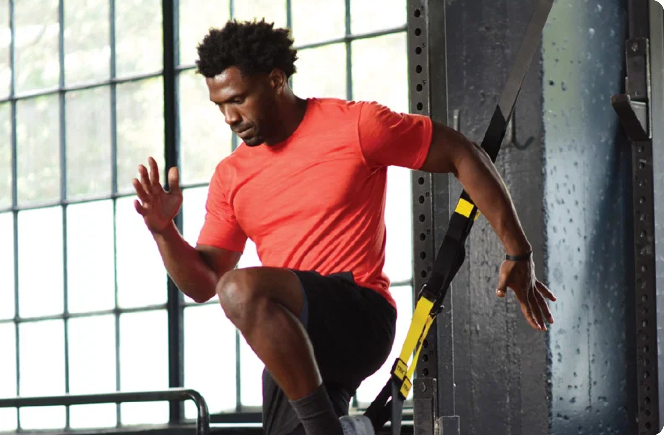 Athlete training with TRX fitness equipment