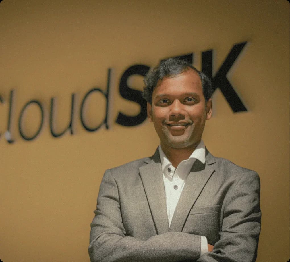 Rahul Sasi, CloudSEK founder, in front of CloudSEK office sign